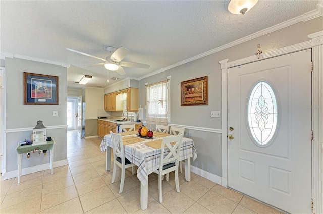 1908 N Brink Ave, Sarasota, FL 34234 - dining space with a textured ceiling, plenty of natural light, light tile patterned floors, ceiling fan, and ornamental molding
