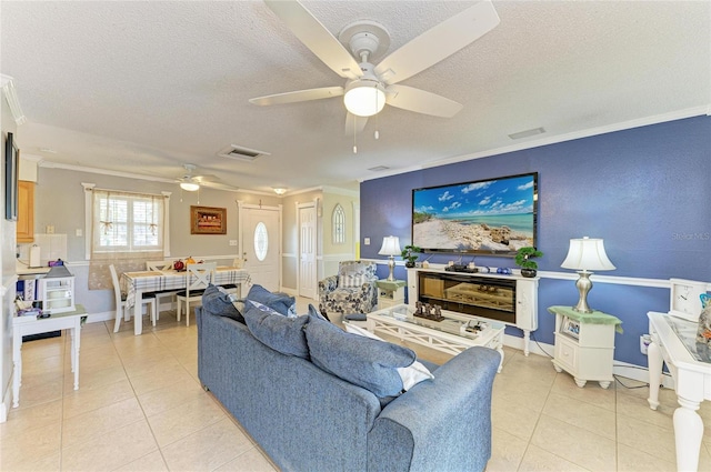 1908 N Brink Ave, Sarasota, FL 34234 - living area featuring ceiling fan, a textured ceiling, light tile patterned floors, and crown molding