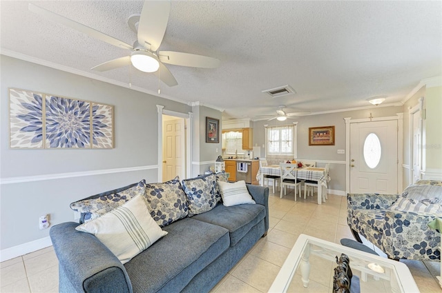 1908 N Brink Ave, Sarasota, FL 34234 - living room featuring ceiling fan, light tile patterned floors, crown molding, and a textured ceiling