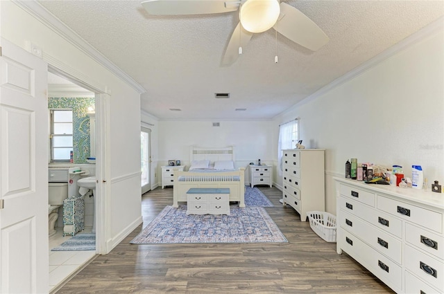 1908 N Brink Ave, Sarasota, FL 34234 - bedroom featuring crown molding, a textured ceiling, wood finished floors, and a ceiling fan