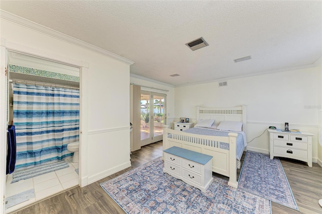 1908 N Brink Ave, Sarasota, FL 34234 - bedroom featuring crown molding, french doors, wood finished floors, and a textured ceiling