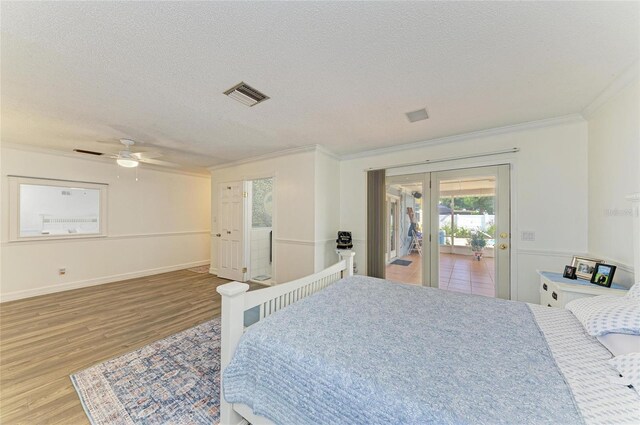 1908 N Brink Ave, Sarasota, FL 34234 - bedroom with access to exterior, crown molding, french doors, wood finished floors, and a textured ceiling