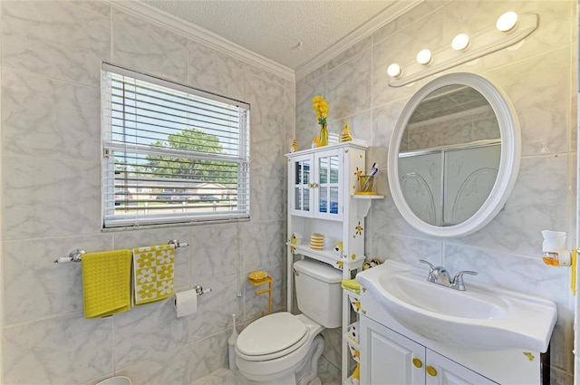 1908 N Brink Ave, Sarasota, FL 34234 - full bath featuring ornamental molding, tile walls, vanity, an enclosed shower, and a textured ceiling