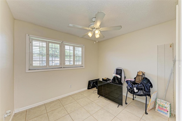 1908 N Brink Ave, Sarasota, FL 34234 - living area with a ceiling fan, tile patterned floors, and a textured ceiling