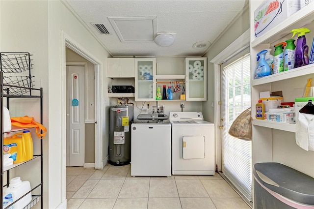 1908 N Brink Ave, Sarasota, FL 34234 - laundry room featuring water heater, attic access, washing machine and clothes dryer, light tile patterned floors, and a textured ceiling