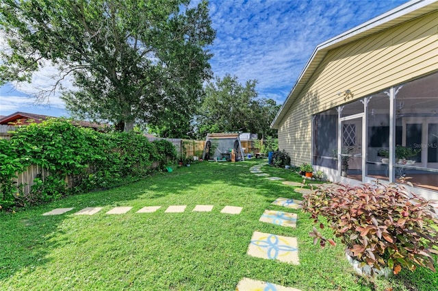 1908 N Brink Ave, Sarasota, FL 34234 - fenced backyard featuring a sunroom and a storage unit