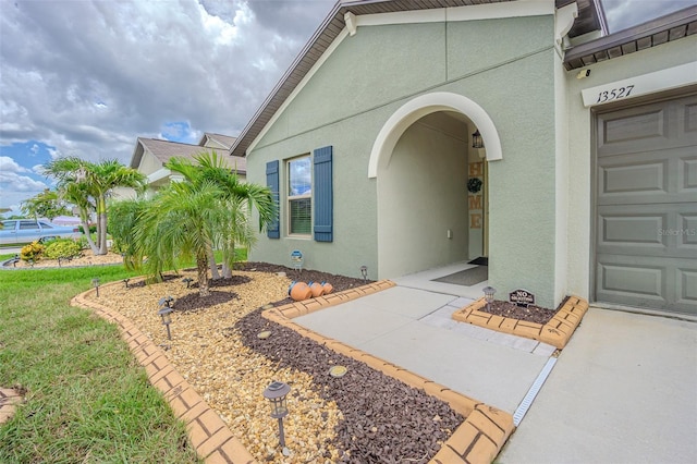 13527 Willow Bluestar Loop, Riverview, FL 33579 - view of exterior entry featuring stucco siding and a garage