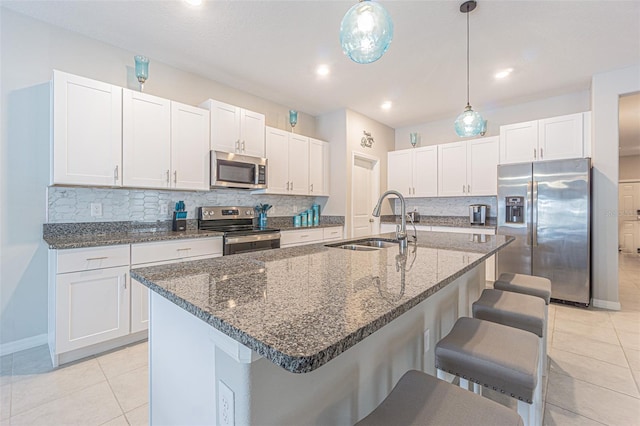 13527 Willow Bluestar Loop, Riverview, FL 33579 - kitchen featuring appliances with stainless steel finishes, light tile patterned flooring, a kitchen breakfast bar, decorative backsplash, and recessed lighting