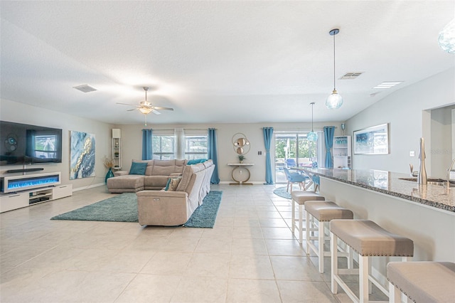 13527 Willow Bluestar Loop, Riverview, FL 33579 - living area with ceiling fan, light tile patterned flooring, and a textured ceiling
