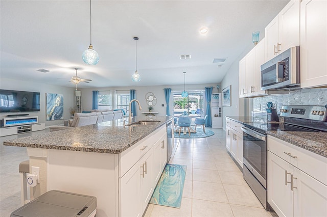 13527 Willow Bluestar Loop, Riverview, FL 33579 - kitchen featuring appliances with stainless steel finishes, plenty of natural light, decorative backsplash, and pendant lighting