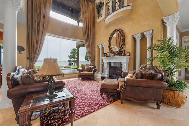 12125 Stonelake Ranch Blvd, Thonotosassa, FL 33592 - living area with ornate columns, a high ceiling, a fireplace, and tile patterned flooring