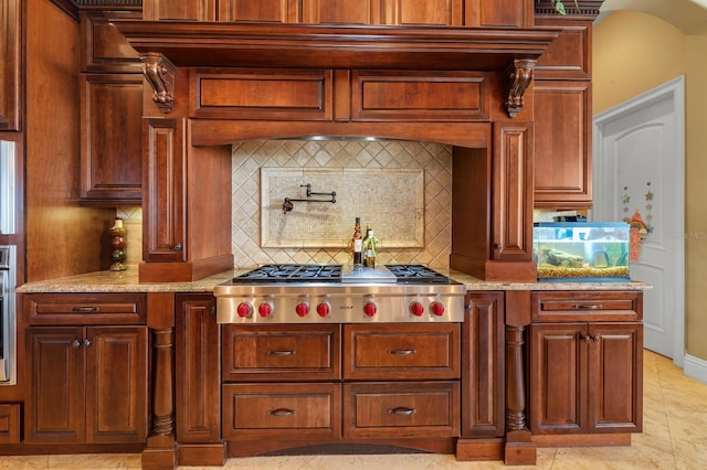 12125 Stonelake Ranch Blvd, Thonotosassa, FL 33592 - kitchen with stainless steel gas cooktop, tasteful backsplash, and light stone countertops