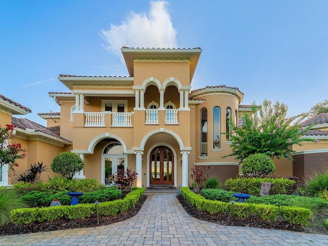12125 Stonelake Ranch Blvd, Thonotosassa, FL 33592 - mediterranean / spanish home with french doors, a balcony, and stucco siding