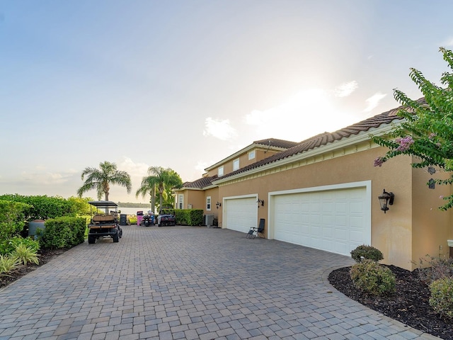 12125 Stonelake Ranch Blvd, Thonotosassa, FL 33592 - view of property exterior with decorative driveway, a garage, and stucco siding
