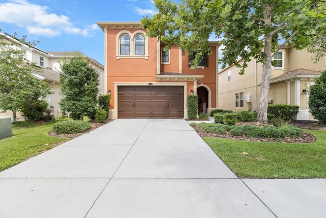3994 Medicci Ln, Wesley Chapel, FL 33543 - view of front of home with driveway, an attached garage, stucco siding, and a front yard