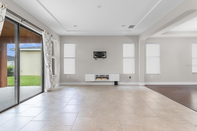 3994 Medicci Ln, Wesley Chapel, FL 33543 - unfurnished living room with baseboards and tile patterned flooring
