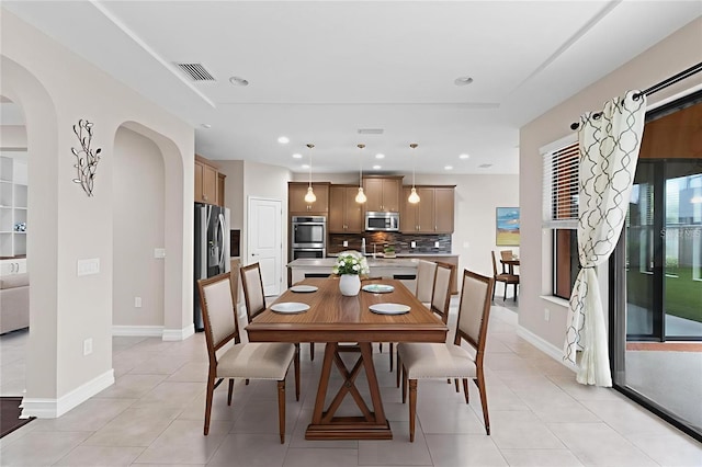 3994 Medicci Ln, Wesley Chapel, FL 33543 - dining room with light tile patterned flooring, arched walkways, and recessed lighting