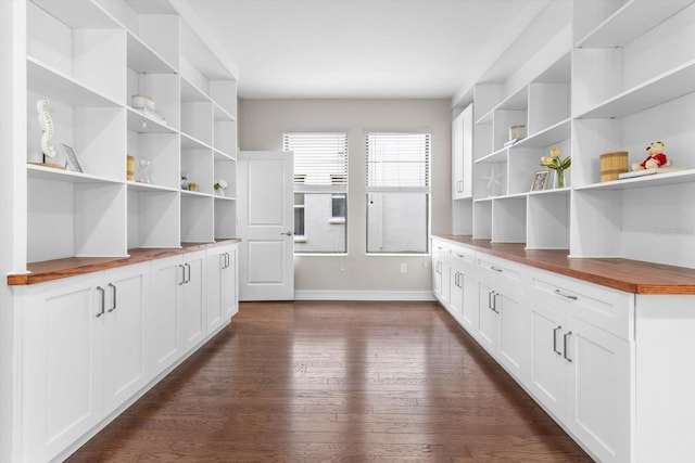 3994 Medicci Ln, Wesley Chapel, FL 33543 - kitchen with open shelves, wood counters, and dark wood finished floors