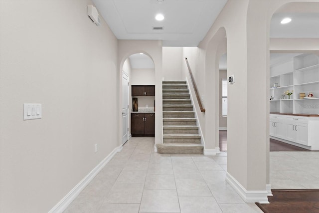 3994 Medicci Ln, Wesley Chapel, FL 33543 - stairs featuring arched walkways and tile patterned flooring