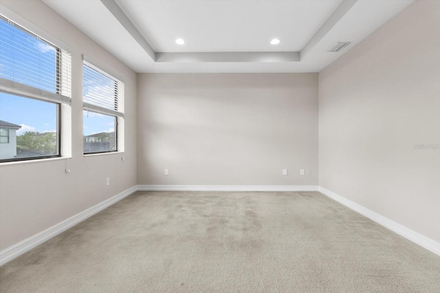 3994 Medicci Ln, Wesley Chapel, FL 33543 - spare room featuring light carpet, a raised ceiling, and recessed lighting