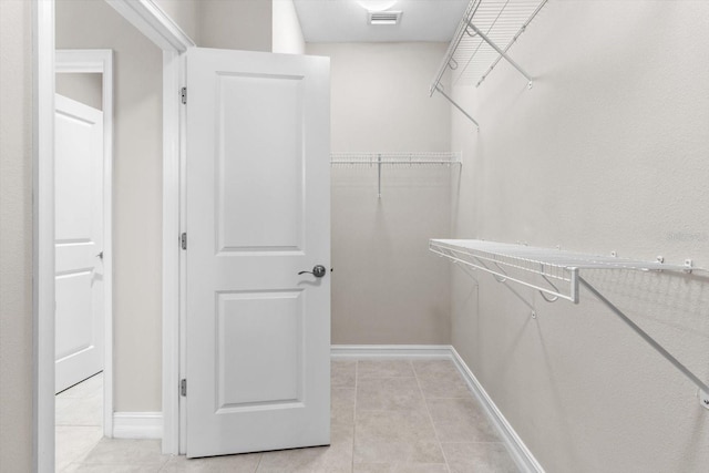 3994 Medicci Ln, Wesley Chapel, FL 33543 - walk in closet with light tile patterned floors