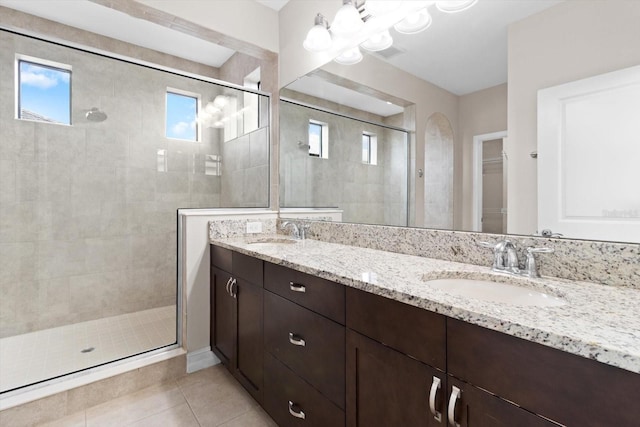 3994 Medicci Ln, Wesley Chapel, FL 33543 - full bathroom with tiled shower, double vanity, tile patterned floors, and a spacious closet