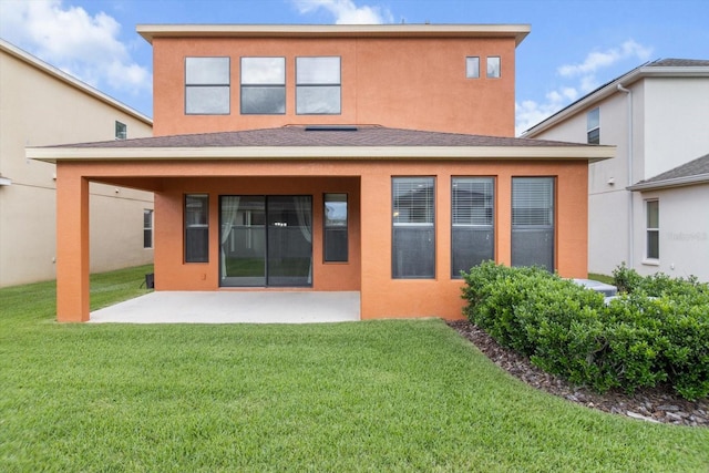 3994 Medicci Ln, Wesley Chapel, FL 33543 - back of property featuring a patio, a yard, and stucco siding