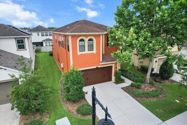 3994 Medicci Ln, Wesley Chapel, FL 33543 - view of front of property featuring stucco siding, a garage, concrete driveway, and a front yard