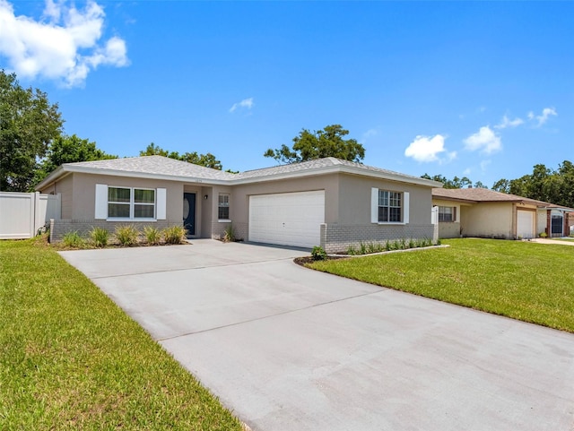 1675 E Grovehill Rd, Palm Harbor, FL 34683 - ranch-style home with a garage, concrete driveway, brick siding, and stucco siding