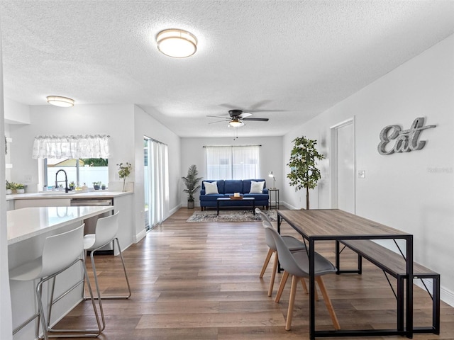1675 E Grovehill Rd, Palm Harbor, FL 34683 - dining room with a textured ceiling, plenty of natural light, wood finished floors, and ceiling fan