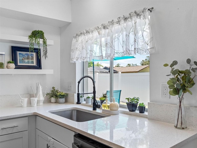 1675 E Grovehill Rd, Palm Harbor, FL 34683 - kitchen featuring light stone countertops and dishwasher