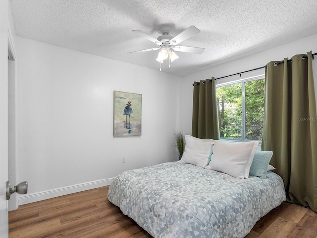 1675 E Grovehill Rd, Palm Harbor, FL 34683 - bedroom featuring wood finished floors, a textured ceiling, and ceiling fan