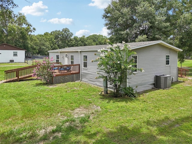 26223 Chianina Dr, Wesley Chapel, FL 33544 - back of house featuring a wooden deck and a yard