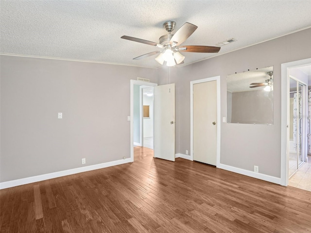 26223 Chianina Dr, Wesley Chapel, FL 33544 - unfurnished room with ceiling fan, a textured ceiling, wood finished floors, and crown molding