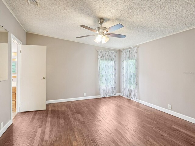 26223 Chianina Dr, Wesley Chapel, FL 33544 - spare room with ceiling fan, wood finished floors, a textured ceiling, and crown molding