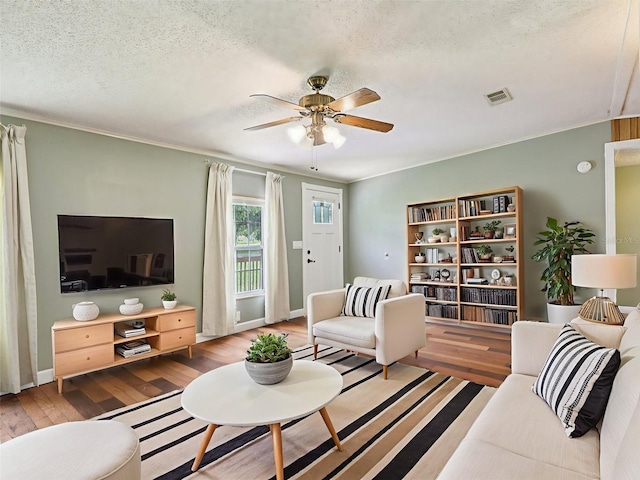 26223 Chianina Dr, Wesley Chapel, FL 33544 - living area with hardwood / wood-style floors, a ceiling fan, crown molding, and a textured ceiling