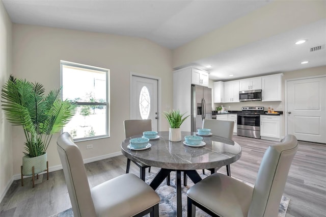 1561 S Martin Luther King Jr Ave, Clearwater, FL 33756 - dining space with light wood-style floors, lofted ceiling, and recessed lighting