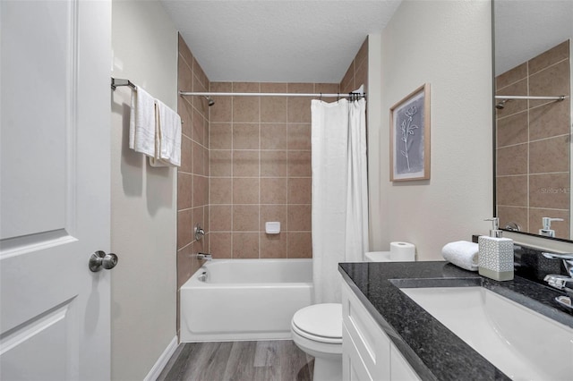 1561 S Martin Luther King Jr Ave, Clearwater, FL 33756 - full bathroom featuring vanity, wood finished floors, shower / bath combination with curtain, and a textured ceiling