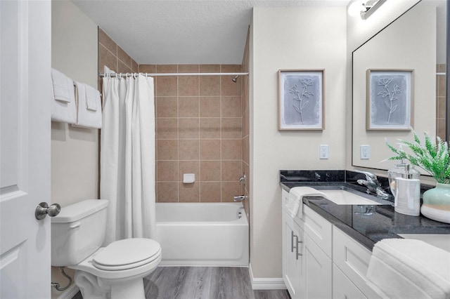 1561 S Martin Luther King Jr Ave, Clearwater, FL 33756 - bathroom with vanity, shower / tub combo with curtain, wood finished floors, and a textured ceiling