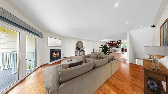 459 Haven Point Dr, Treasure Island, FL 33706 - living area featuring a fireplace with flush hearth, light wood finished floors, and recessed lighting