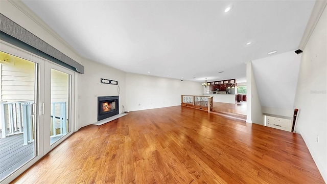459 Haven Point Dr, Treasure Island, FL 33706 - unfurnished living room featuring light wood-style flooring, a fireplace with flush hearth, and recessed lighting