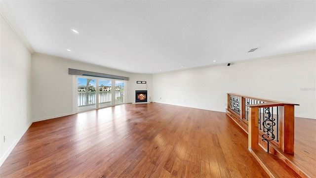 459 Haven Point Dr, Treasure Island, FL 33706 - unfurnished living room featuring wood finished floors, a warm lit fireplace, and recessed lighting