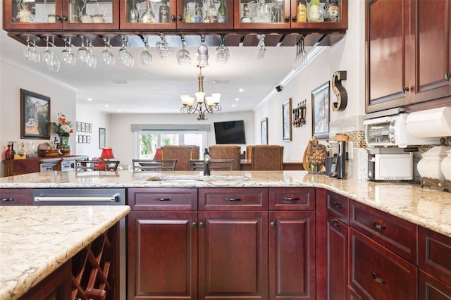 459 Haven Point Dr, Treasure Island, FL 33706 - kitchen featuring open floor plan, dark brown cabinets, ornamental molding, light stone counters, and a chandelier