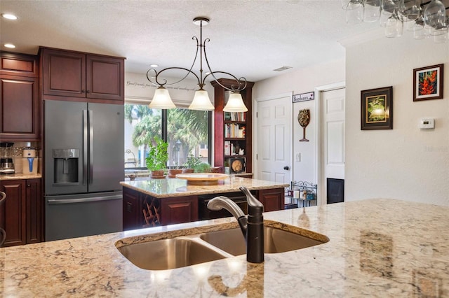 459 Haven Point Dr, Treasure Island, FL 33706 - kitchen featuring stainless steel fridge, light stone countertops, pendant lighting, a textured ceiling, and recessed lighting
