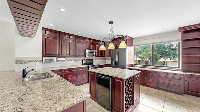 459 Haven Point Dr, Treasure Island, FL 33706 - kitchen with beverage cooler, stainless steel appliances, light stone countertops, pendant lighting, and backsplash