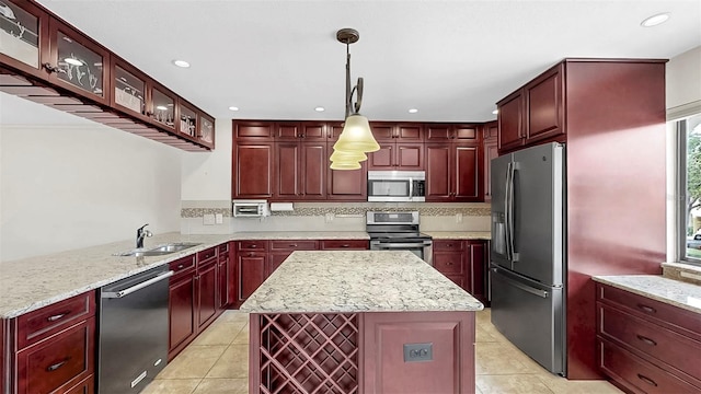 459 Haven Point Dr, Treasure Island, FL 33706 - kitchen with appliances with stainless steel finishes, dark brown cabinets, light tile patterned floors, a center island, and recessed lighting