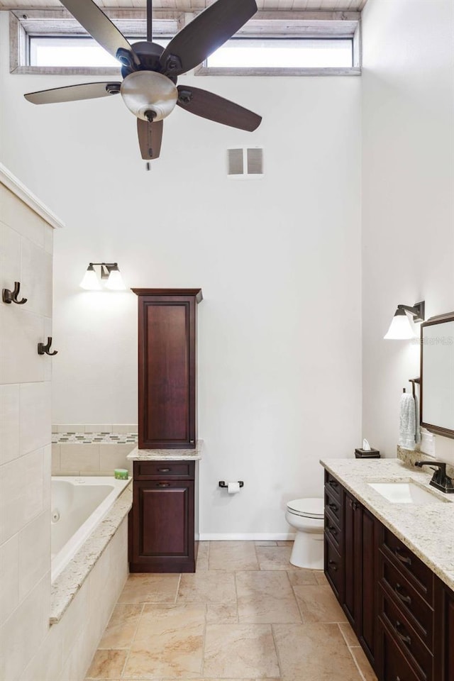 459 Haven Point Dr, Treasure Island, FL 33706 - full bathroom with tiled bath, vanity, ceiling fan, and stone tile flooring