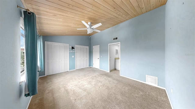 459 Haven Point Dr, Treasure Island, FL 33706 - unfurnished bedroom with multiple closets, vaulted ceiling, wooden ceiling, carpet floors, and a ceiling fan