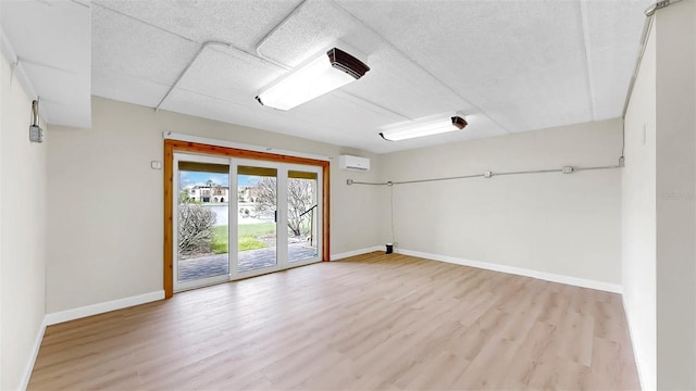 459 Haven Point Dr, Treasure Island, FL 33706 - unfurnished room featuring light wood finished floors and a wall mounted air conditioner