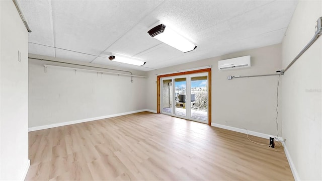 459 Haven Point Dr, Treasure Island, FL 33706 - unfurnished room with a wall mounted air conditioner, wood finished floors, and a textured ceiling